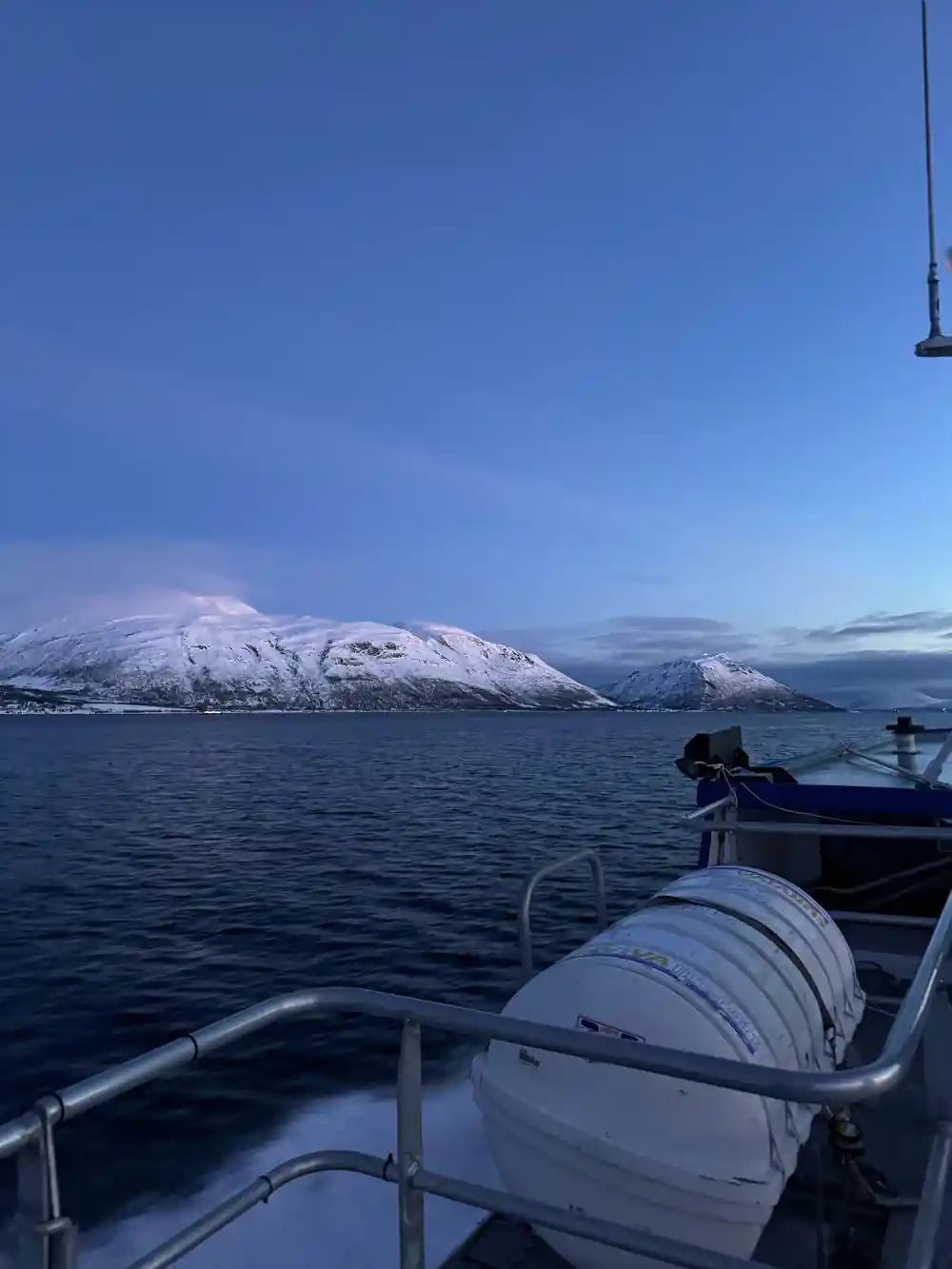 The bow rail and coiled line with mountains beyond
