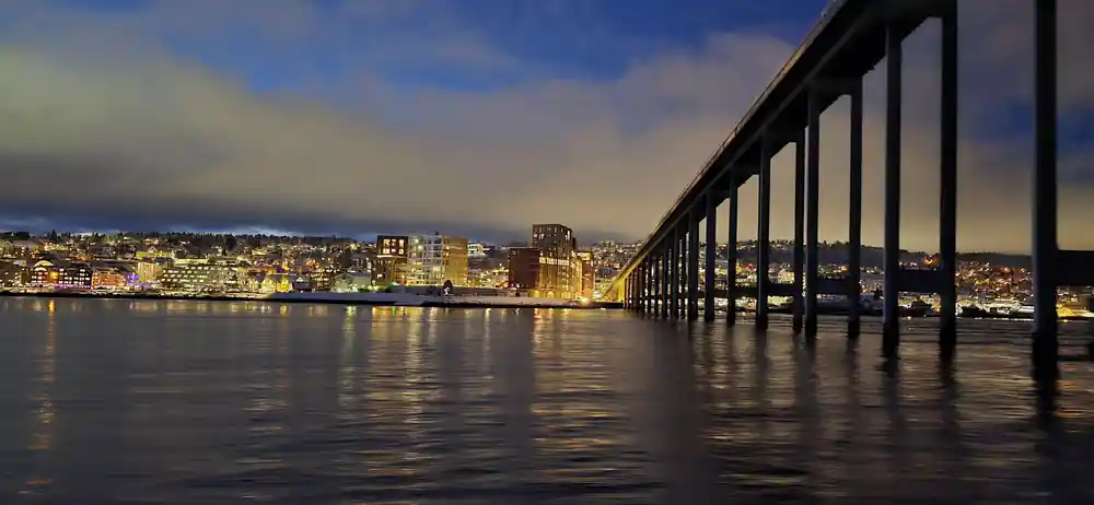 The Tromso bridge and waterfront lit at dusk